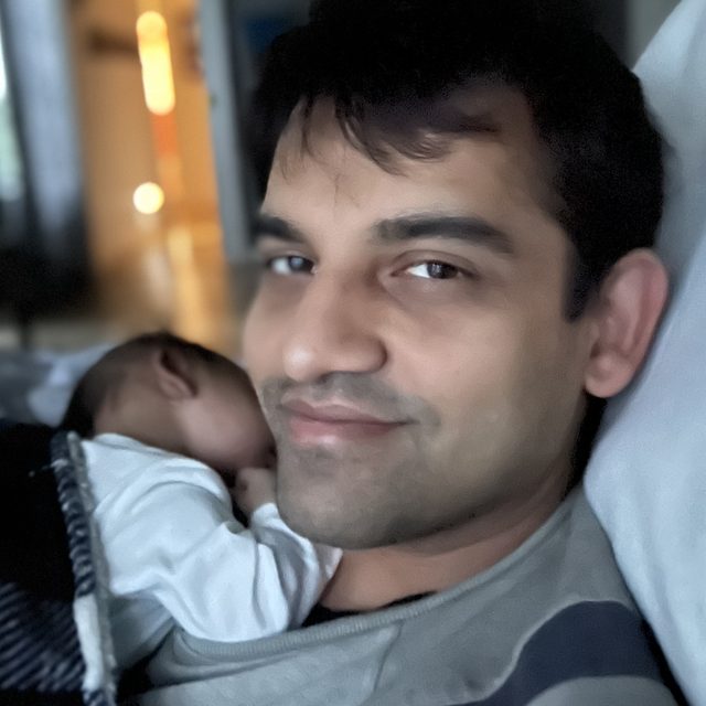 Viral Parekh, the person behind Banavu, with a sleeping newborn